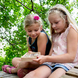 2 children holding and looking into the Huckleberry bug box 