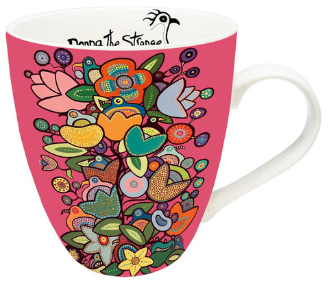 Mug with an image of flowers and birds on a pink background. The top of the artist's signature can be seen on the inside of the mug.