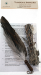 Close product shot of smudge kit showing feather, sage and instructions